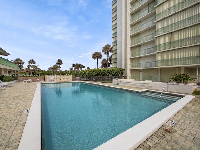 view of swimming pool with a patio