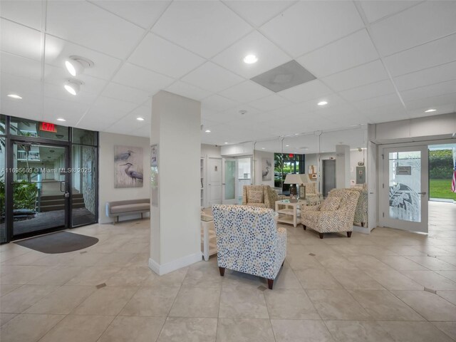9940 S Ocean Dr Unit 508, Jensen Beach, FL 34957 - living room featuring a paneled ceiling and light tile patterned floors