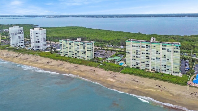 bird's eye view featuring a water view and a beach view