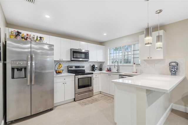 kitchen with tasteful backsplash, white cabinetry, sink, and appliances with stainless steel finishes