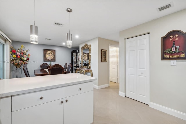 kitchen featuring white cabinetry and pendant lighting