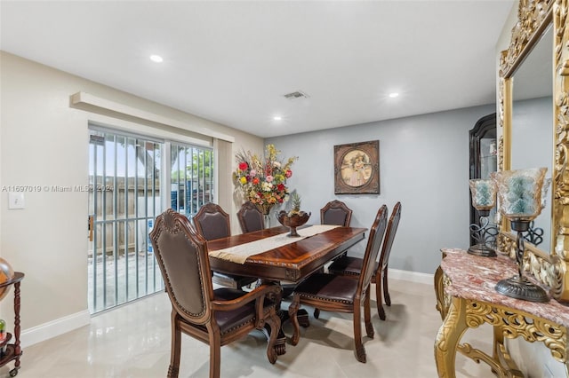 dining room with a water view and light tile patterned flooring