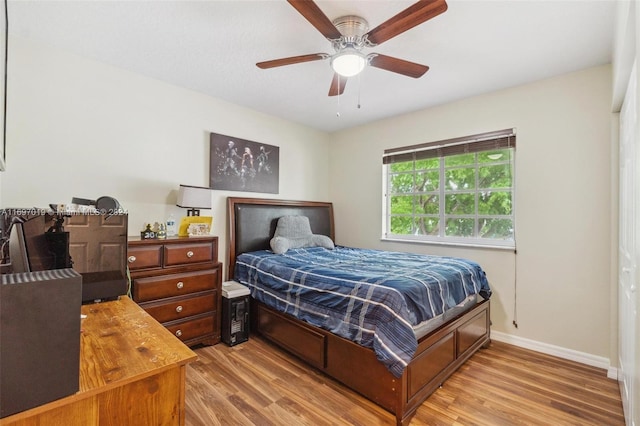 bedroom with ceiling fan and light hardwood / wood-style floors