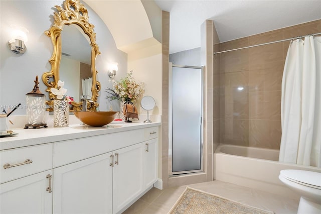 full bathroom featuring tile patterned floors, shower / tub combo with curtain, vanity, and toilet