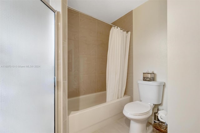 bathroom featuring tile patterned floors, shower / bath combination with curtain, and toilet