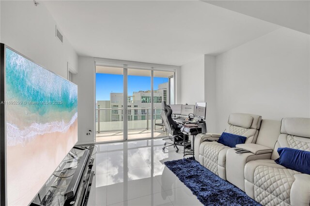 tiled living room with a wall of windows