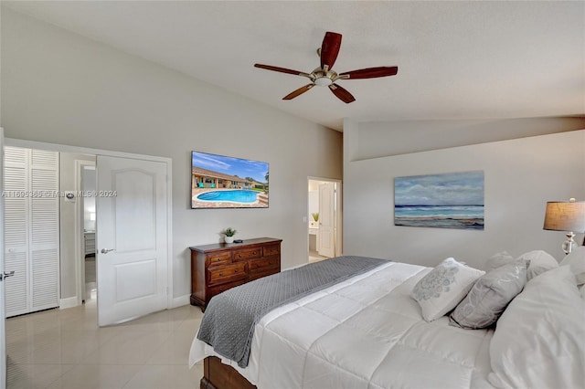 tiled bedroom featuring connected bathroom, ceiling fan, and lofted ceiling