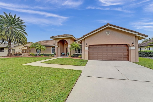 mediterranean / spanish-style house featuring a garage and a front lawn