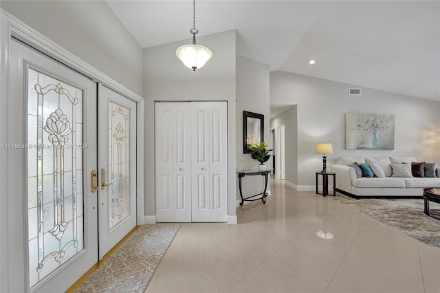 tiled foyer entrance with french doors and vaulted ceiling