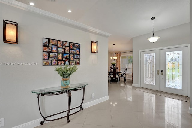 foyer entrance featuring french doors and a chandelier