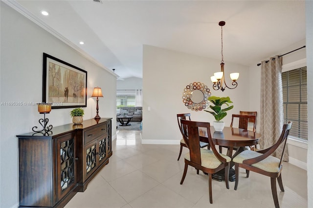 tiled dining room featuring vaulted ceiling and a notable chandelier