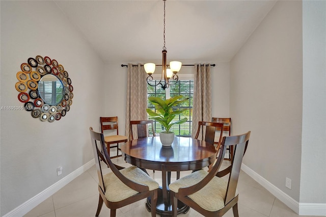 tiled dining room with a notable chandelier and lofted ceiling