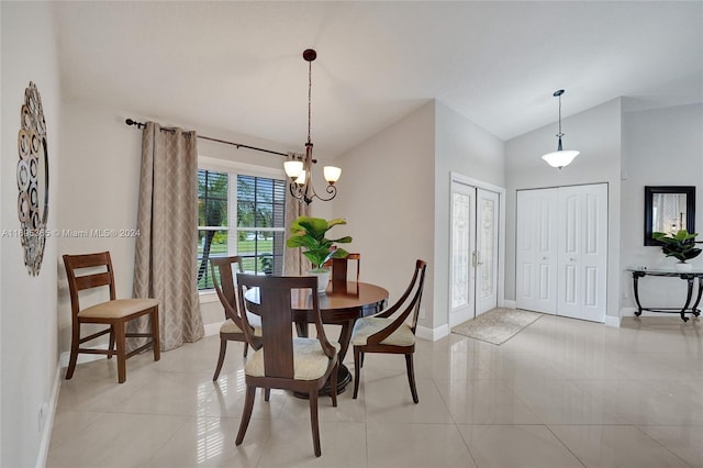 dining space with light tile patterned floors, a chandelier, and vaulted ceiling