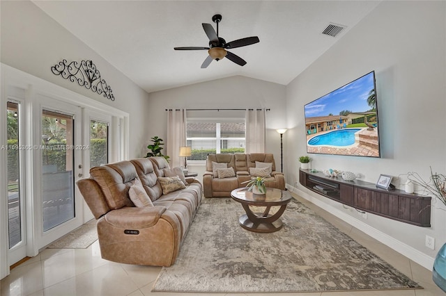 tiled living room featuring ceiling fan, french doors, a wealth of natural light, and vaulted ceiling