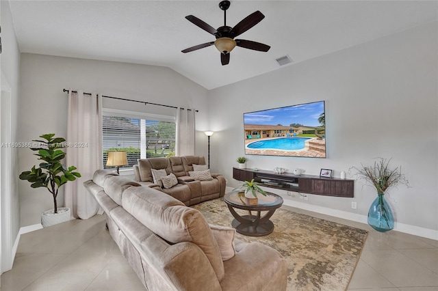 living room with ceiling fan, light tile patterned flooring, and lofted ceiling