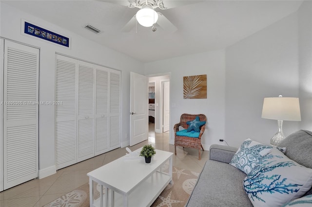 living room with light tile patterned floors and ceiling fan