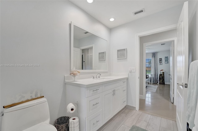 bathroom featuring vanity and toilet