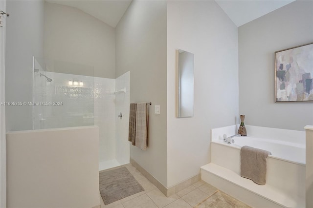 bathroom with tile patterned floors, shower with separate bathtub, and vaulted ceiling