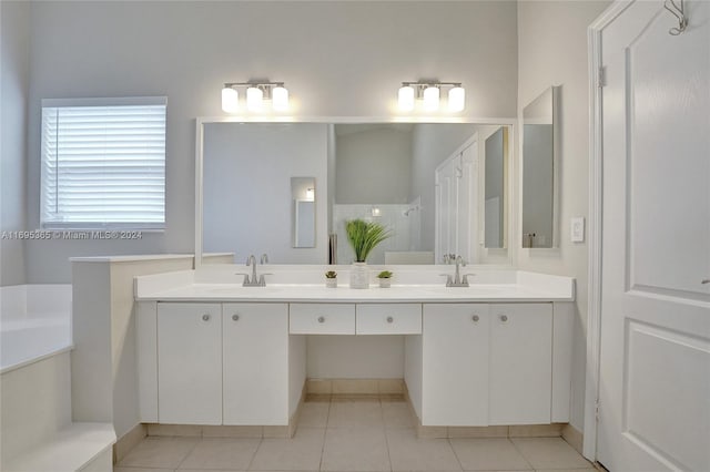 bathroom featuring tile patterned floors, vanity, and a bath