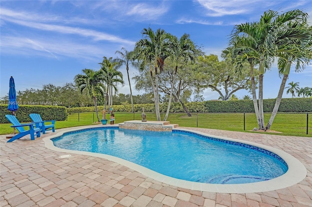 view of pool featuring a lawn and a patio