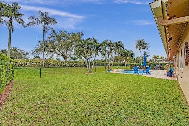 view of yard with a patio area and a fenced in pool