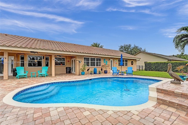 view of swimming pool with ceiling fan and a patio area