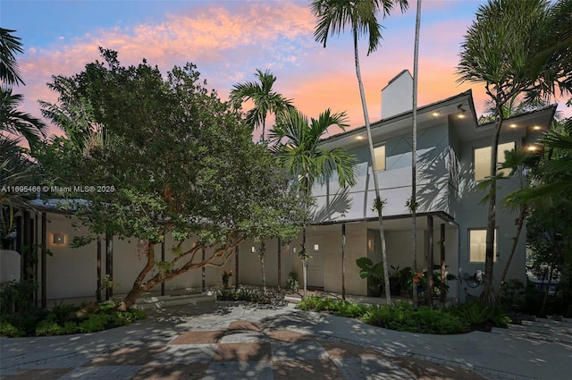 exterior space featuring a patio area and stucco siding