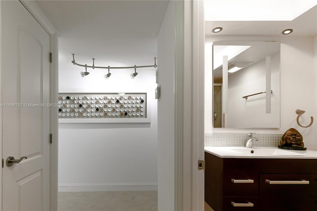 bathroom featuring vanity, tasteful backsplash, and tile patterned floors