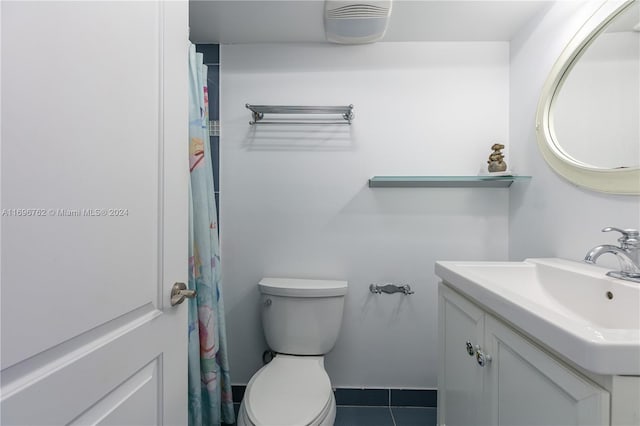 bathroom with tile patterned floors, vanity, and toilet