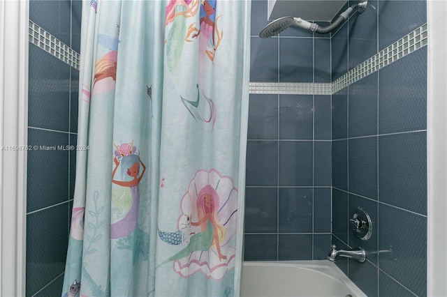 bathroom with shower / bathtub combination with curtain