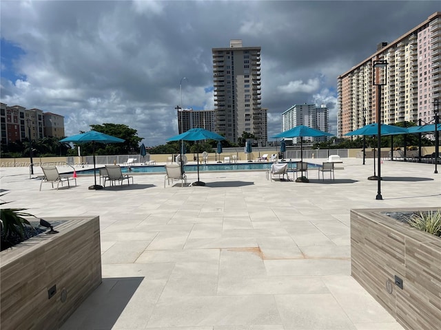 view of property's community with a patio area and a swimming pool