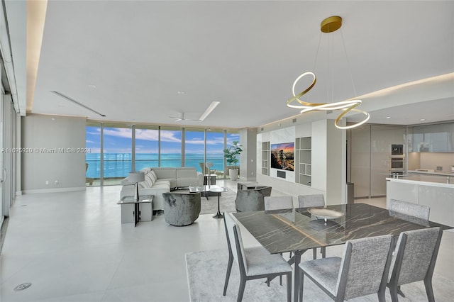 dining space with a water view and a wall of windows