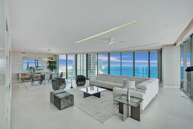 living room featuring a water view, expansive windows, and ceiling fan