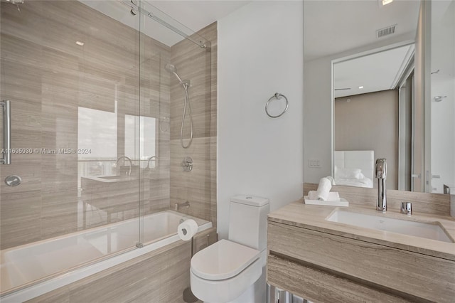 full bathroom with shower / bath combination with glass door, vanity, and toilet