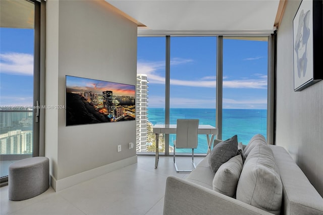 living room with a water view and a wall of windows