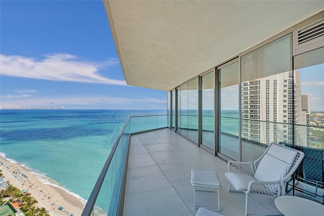 balcony with a beach view and a water view