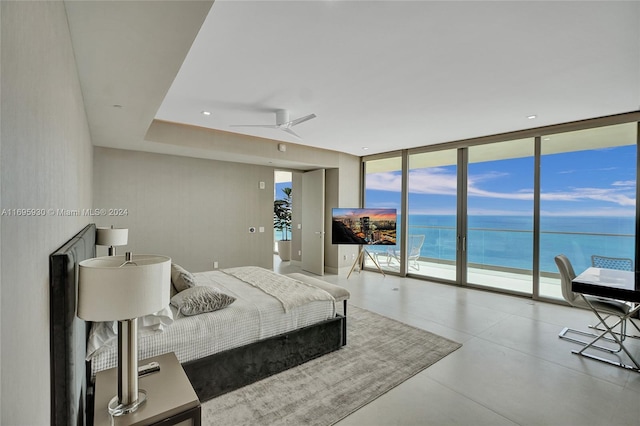 bedroom featuring access to exterior, ceiling fan, and expansive windows