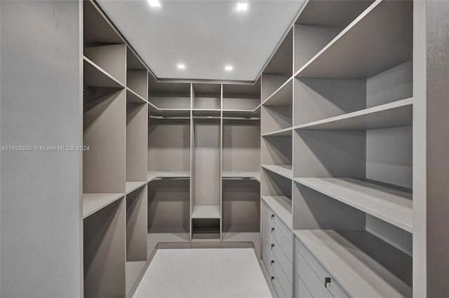 walk in closet with tile patterned floors