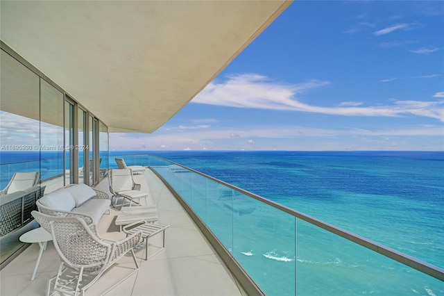 balcony with an outdoor hangout area and a water view