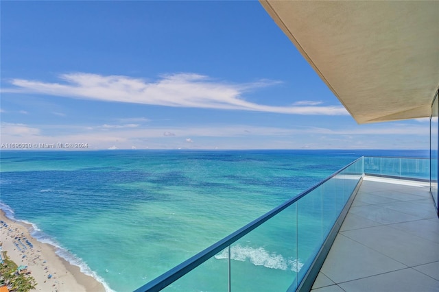 balcony with a beach view and a water view