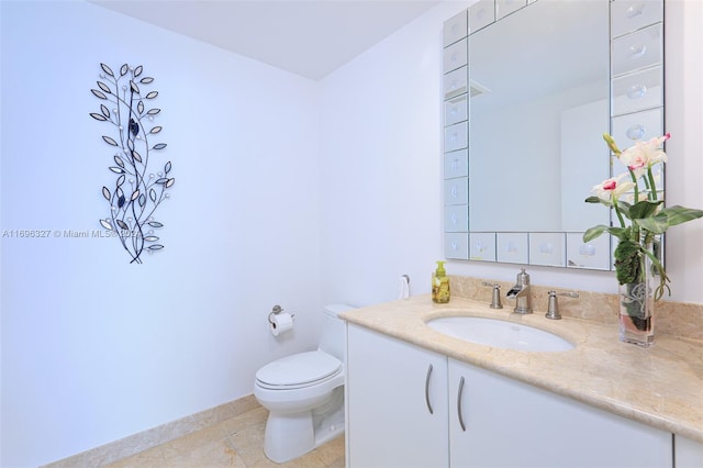 bathroom featuring tile patterned floors, vanity, and toilet