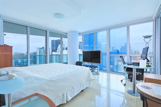 bedroom with a wall of windows and multiple windows