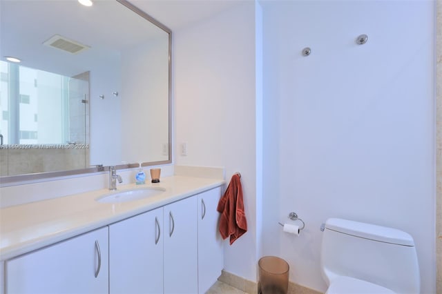 bathroom with vanity and toilet