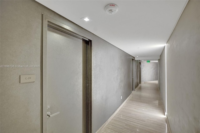 hallway with light hardwood / wood-style flooring