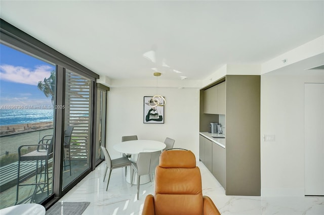 dining room featuring floor to ceiling windows and sink