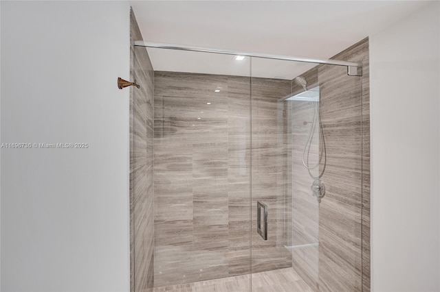 bathroom with a shower with door