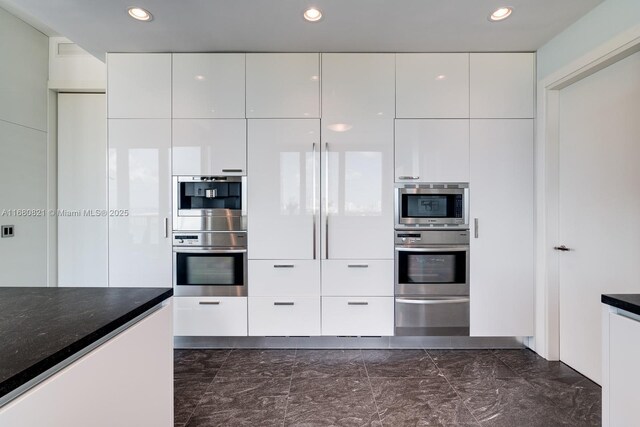 2627 S Bayshore Dr Unit 3201, Miami, FL 33133 - kitchen with marble finish floor, modern cabinets, white cabinets, and appliances with stainless steel finishes
