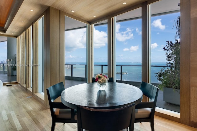 2627 S Bayshore Dr Unit 3201, Miami, FL 33133 - dining room featuring a water view, a healthy amount of sunlight, light wood-style flooring, and floor to ceiling windows