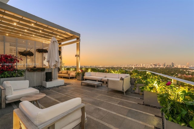 2627 S Bayshore Dr Unit 3201, Miami, FL 33133 - patio terrace at dusk with a pergola and outdoor lounge area