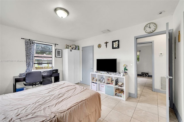 bedroom featuring light tile patterned floors